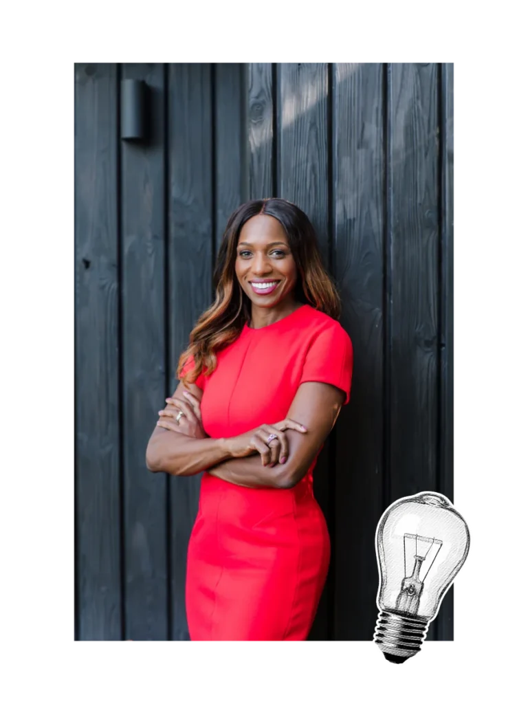 Caroline Flanagan, author of Babyproof Your Career, smiling confidently in a red dress