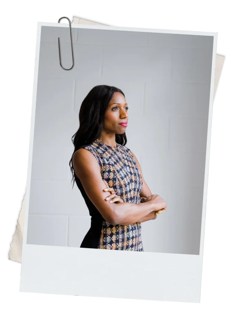 Caroline Flanagan, arms crossed, representing confidence and resilience as a Black lawyer and coach